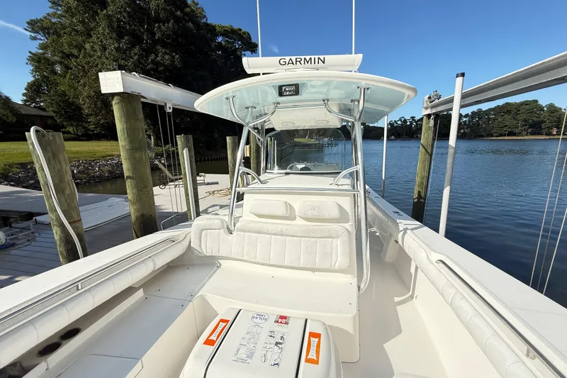 Slide: The Image of 2009 Regulator 34SS boat on a sunny lake, featuring dual outboard motors. - 24