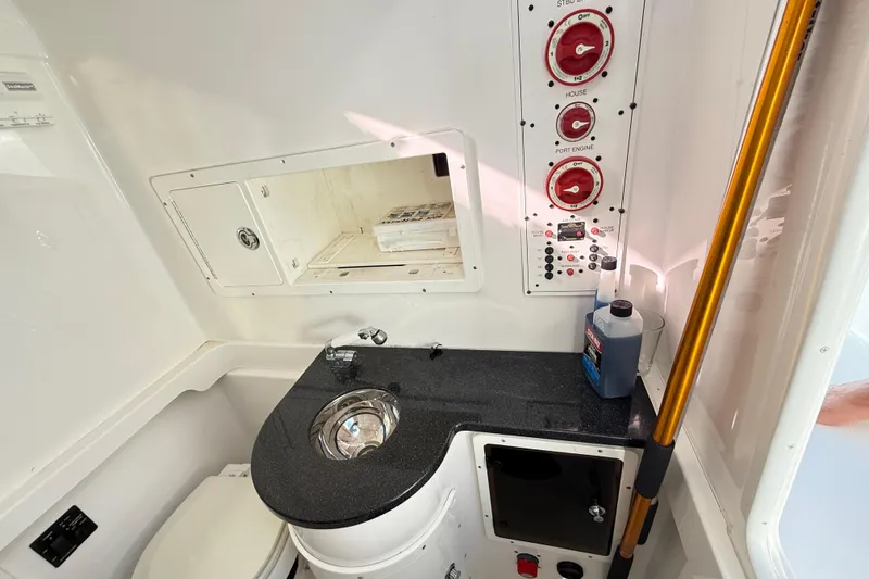 Slide: The Image of 2009 Regulator 34SS boat with dual engines on a calm lake. - 26