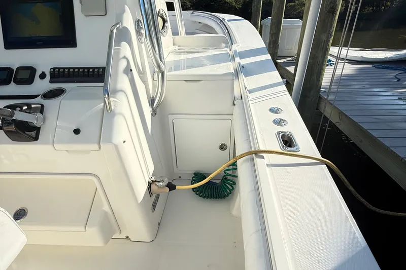 Slide: The Image of 2009 Regulator 34SS boat cockpit with Garmin navigation displays and steering wheel. - 30