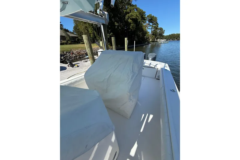 Slide: The Image of 2009 Regulator 34SS boat with covered seating, docked by a scenic waterfront. - 46