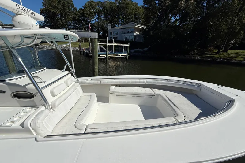 Slide: The Image of 2009 Regulator 34SS boat with spacious seating, docked near a waterfront property. - 48