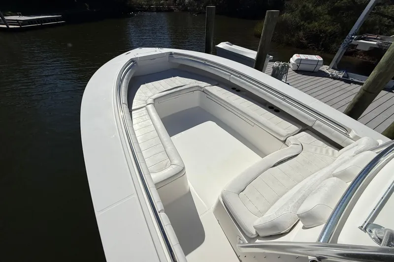 Slide: The Image of 2009 Regulator 34SS boat with spacious seating, docked by the water. - 49