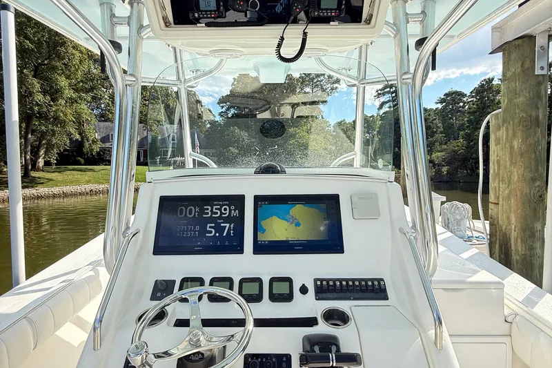 Slide: The Image of 2009 Regulator 34SS boat cockpit with navigation screens and steering wheel. - 9