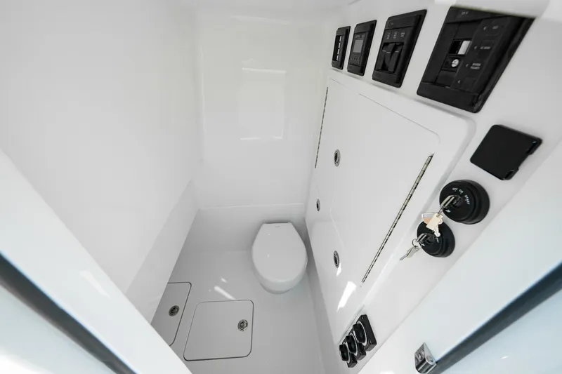 Slide: The Image of 2026 Valhalla V-29 Hybrid boat interior with modern controls and compact toilet. - 9