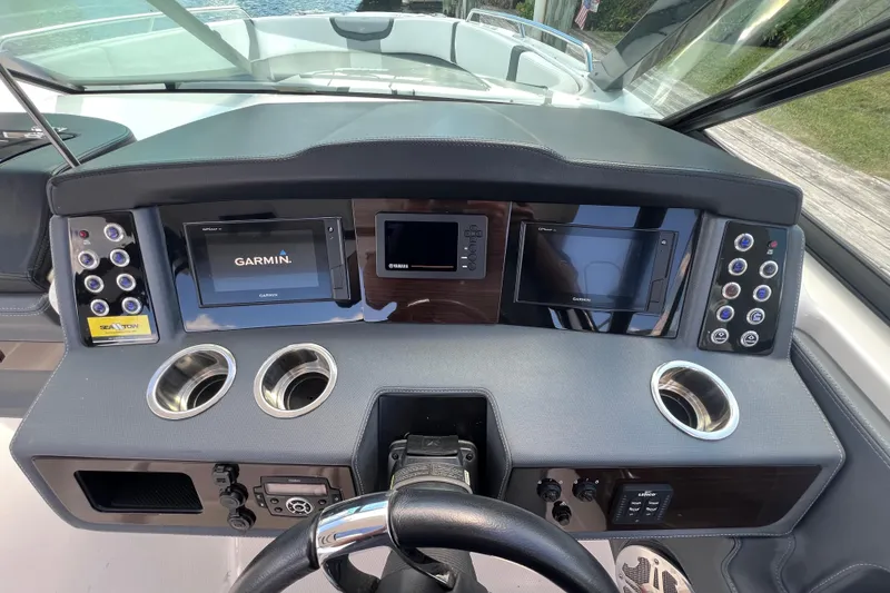 Slide: The Image of 2020 Chaparral 280 OSX dashboard with Garmin displays and control panels. - 16