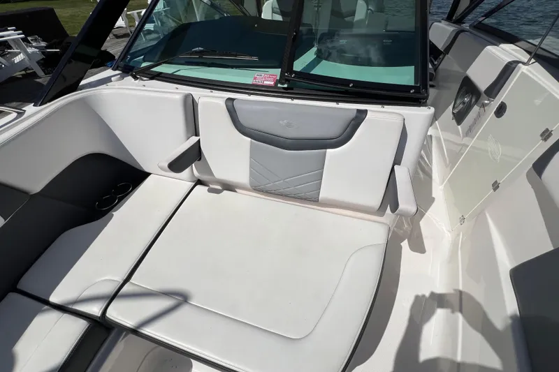 Slide: The Image of 2020 Chaparral 280 OSX boat interior with white seating and windshield. - 18