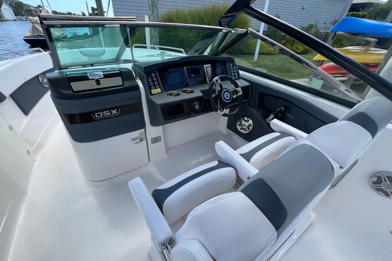 Slide: The Image of 2020 Chaparral 280 OSX boat interior with modern dashboard and seating. - 19