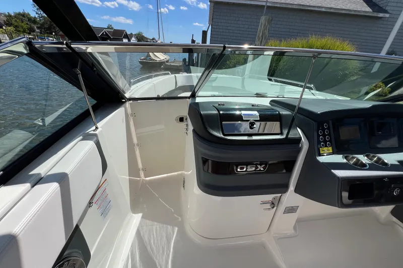 Slide: The Image of 2020 Chaparral 280 OSX boat interior with sleek dashboard and waterfront view. - 21