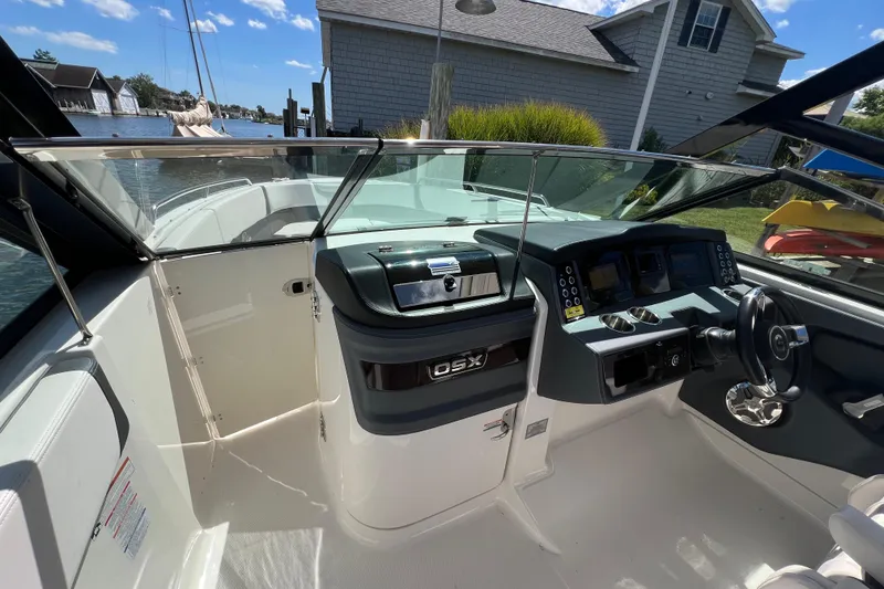 Slide: The Image of 2020 Chaparral 280 OSX boat cockpit with modern controls and waterfront view. - 22