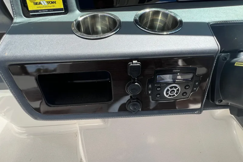 Slide: The Image of Dashboard of 2020 Chaparral 280 OSX with audio system and cup holders. - 31