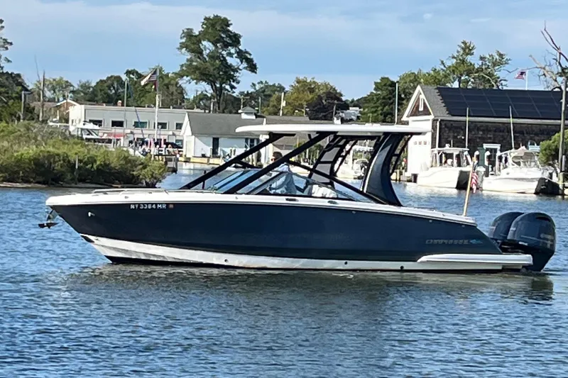 Slide: The Image of 2020 Chaparral 280 OSX boat on calm water near marina. - 43