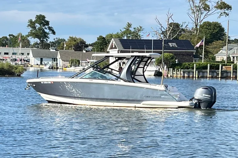 Slide: The Image of 2020 Chaparral 280 OSX boat cruising on a calm river near a marina. - 6