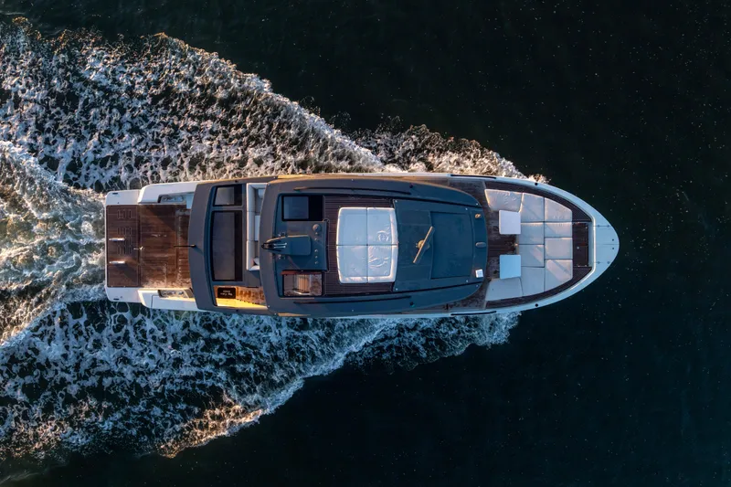 Slide: The Image of Aerial view of 2024 Bluegame BGX63 yacht cruising on open water. - 12