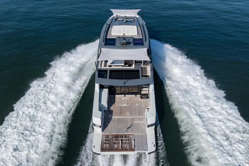Slide: The Image of 2024 Bluegame BGX63 yacht cruising on open water, aerial rear view. - 15