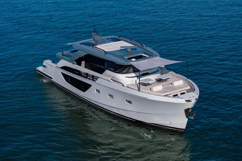Slide: The Image of 2024 Bluegame BGX63 yacht cruising on open water, showcasing sleek design and luxury features. - 18