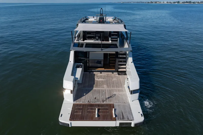 Slide: The Image of 2024 Bluegame BGX63 yacht on open water, showcasing spacious deck and modern design. - 19