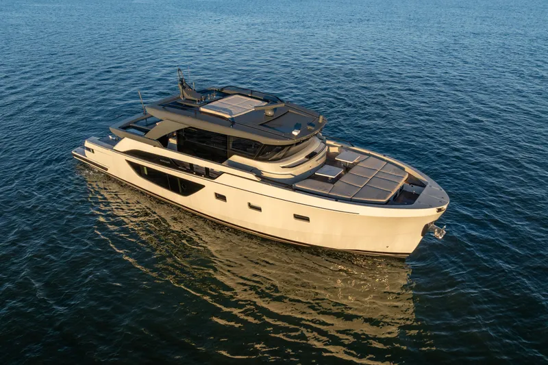 Slide: The Image of 2024 Bluegame BGX63 yacht cruising on calm blue waters. - 2