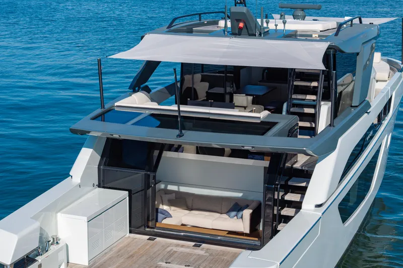Slide: The Image of 2024 Bluegame BGX63 yacht with modern design, spacious deck, and luxurious seating on the water. - 27