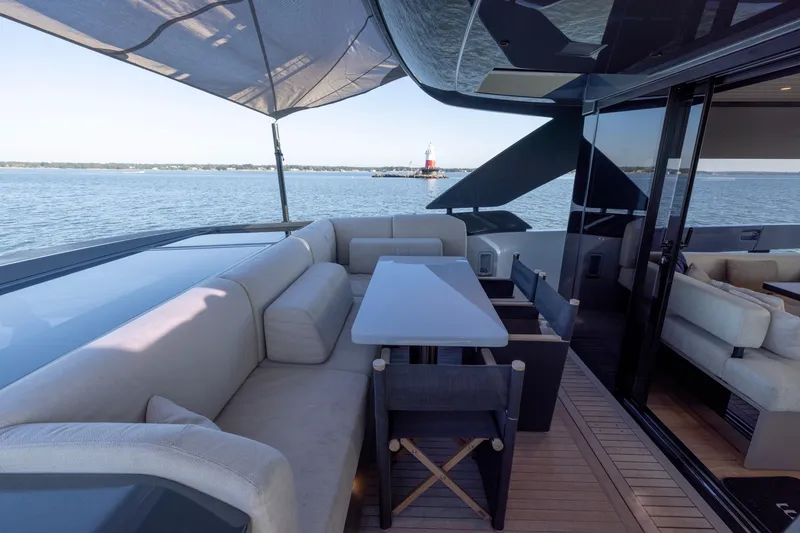 Slide: The Image of Luxurious 2024 Bluegame BGX63 yacht deck with seating, table, and ocean view. - 29