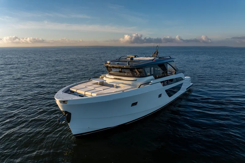 Slide: The Image of 2024 Bluegame BGX63 yacht cruising on open sea at sunset. - 4