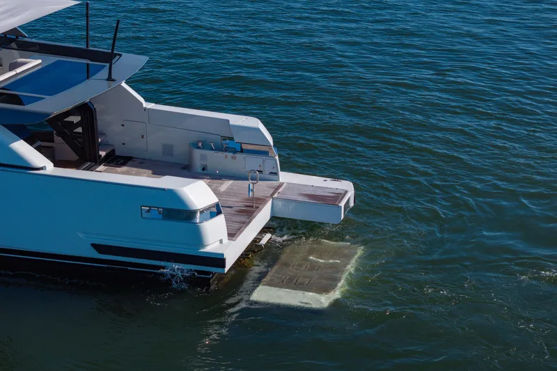 Slide: The Image of 2024 Bluegame BGX63 yacht with extended swim platform on calm water. - 40