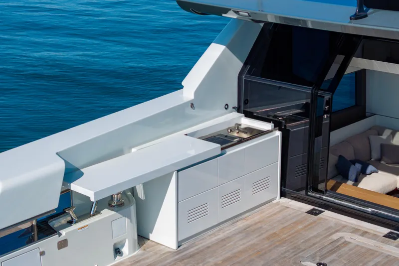 Slide: The Image of 2024 Bluegame BGX63 yacht deck with sleek outdoor kitchen and seating area. - 45