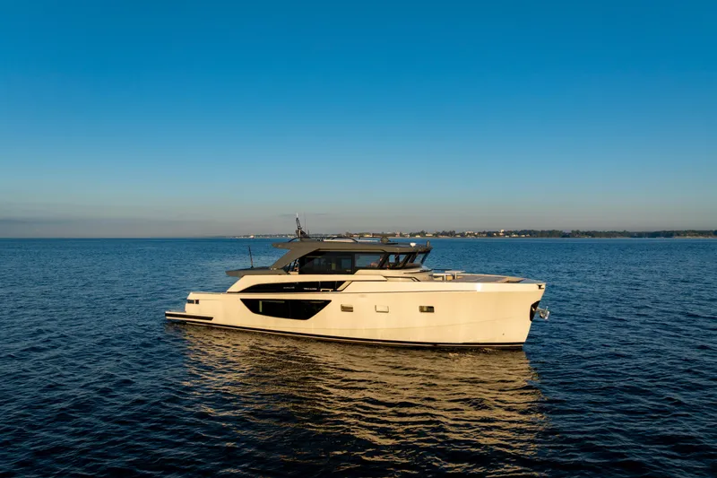 Slide: The Image of 2024 Bluegame BGX63 yacht cruising on calm blue waters under a clear sky. - 5