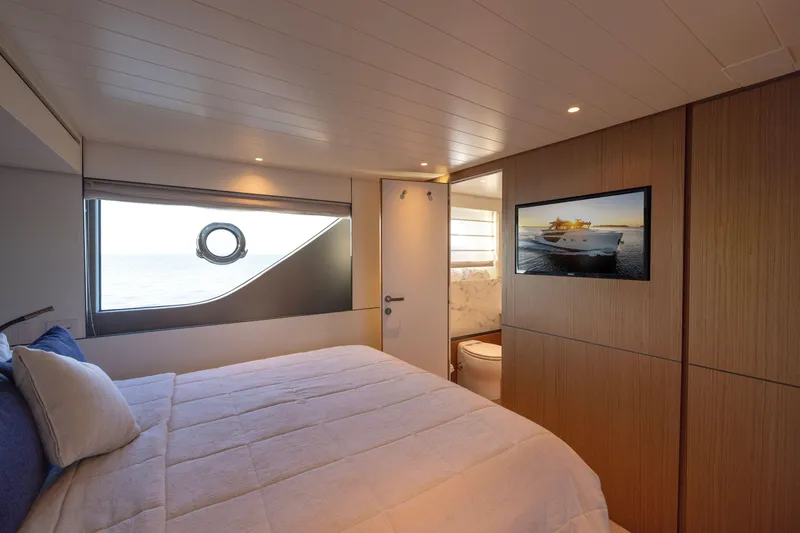 Slide: The Image of Luxurious interior of 2024 Bluegame BGX63 yacht bedroom with ocean view and modern amenities. - 54