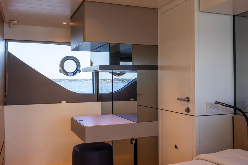 Slide: The Image of Interior of 2024 Bluegame BGX63 yacht, featuring modern design and ocean view through porthole. - 55