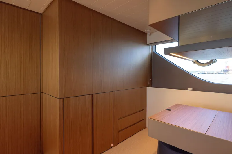 Slide: The Image of Interior of 2024 Bluegame BGX63 yacht with sleek wood paneling and modern design. - 56
