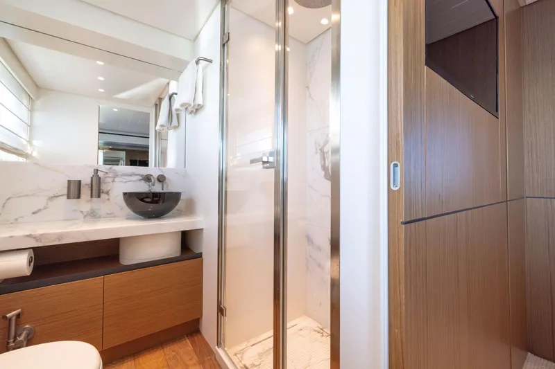 Slide: The Image of Luxurious bathroom in 2024 Bluegame BGX63 yacht with modern fixtures and marble accents. - 58