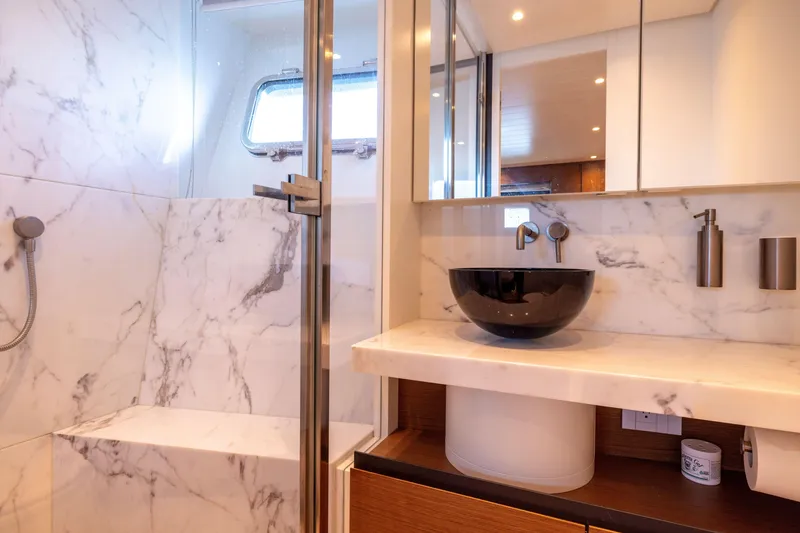 Slide: The Image of Luxurious marble bathroom in 2024 Bluegame BGX63 yacht with modern fixtures and elegant design. - 65