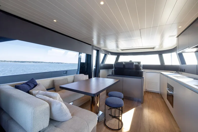 Slide: The Image of Luxurious interior of 2024 Bluegame BGX63 yacht with modern seating and panoramic windows. - 69