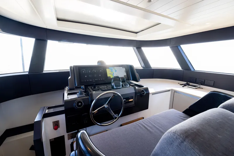 Slide: The Image of 2024 Bluegame BGX63 yacht helm with modern navigation equipment and panoramic windows. - 76