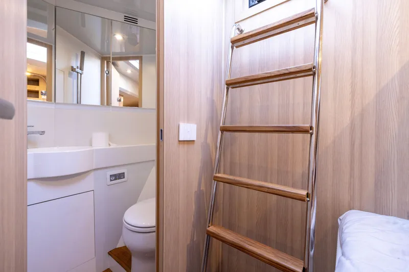 Slide: The Image of 2024 Bluegame BGX63 yacht interior with wooden ladder and modern bathroom. - 83
