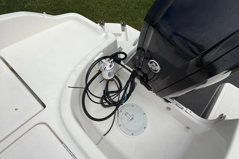 Slide: The Image of 2016 Bayliner Element F18 boat engine area with cables and fuel filter. - 10
