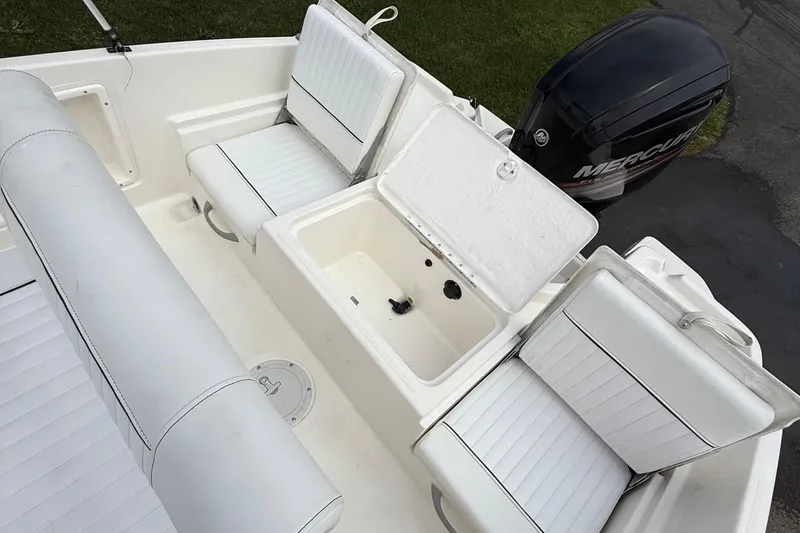 Slide: The Image of 2016 Bayliner Element F18 boat interior with white seating and Mercury outboard motor. - 12