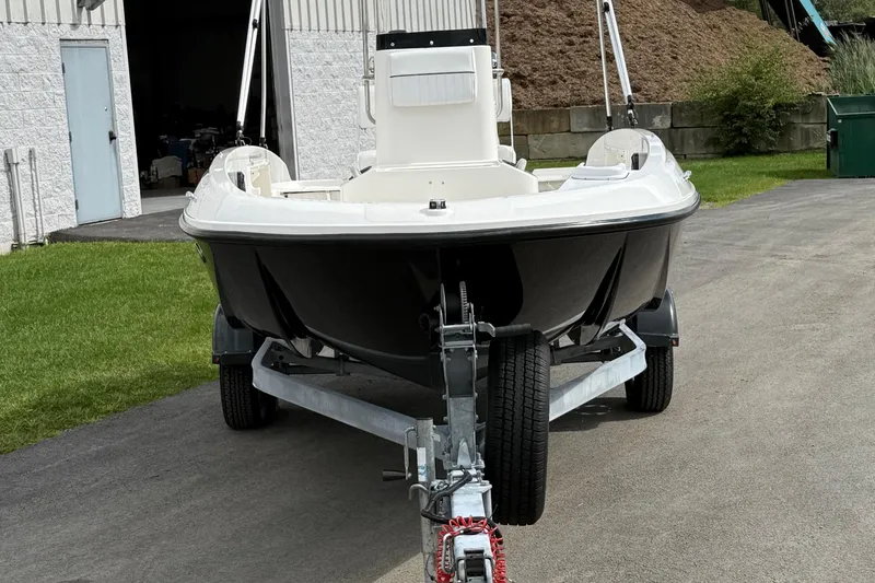 Slide: The Image of 2016 Bayliner Element F18 boat on trailer, parked outside a building. - 13