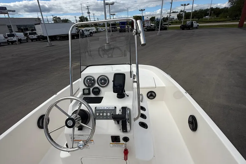 Slide: The Image of 2016 Bayliner Element F18 boat dashboard with steering wheel and gauges. - 18