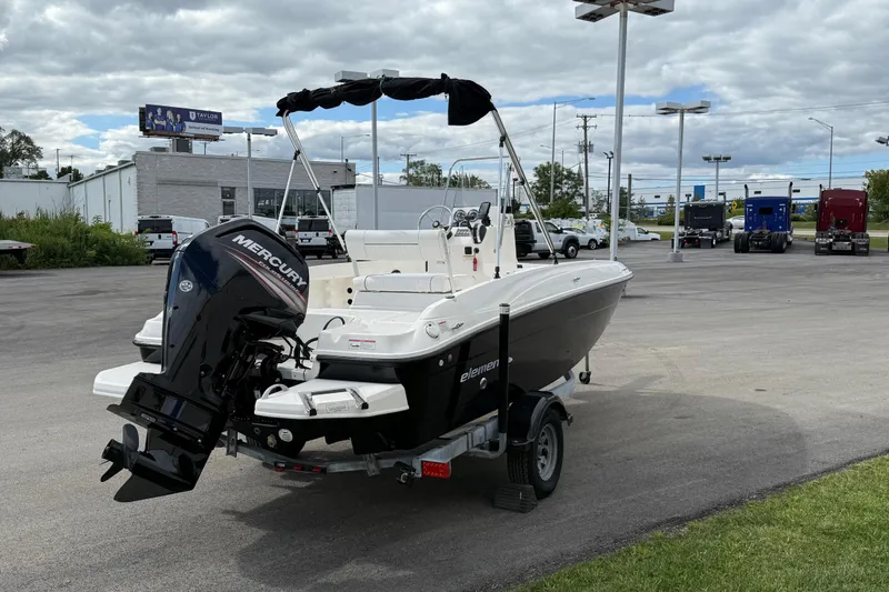 Slide: The Image of 2016 Bayliner Element F18 boat with Mercury engine on trailer in parking lot. - 19