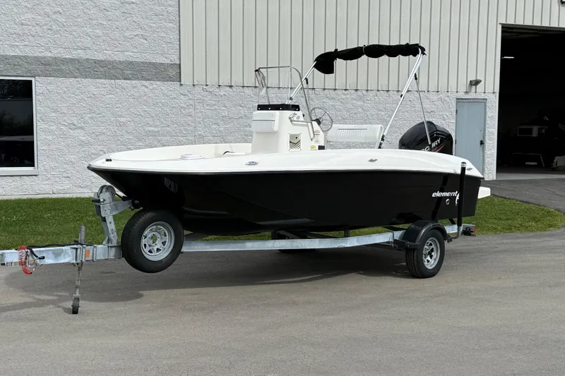 Slide: The Image of 2016 Bayliner Element F18 boat on trailer outside a building. - 28