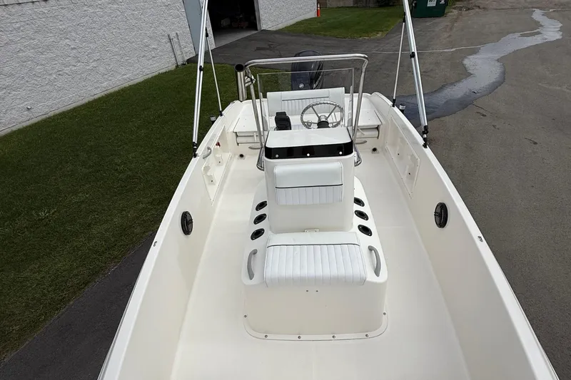 Slide: The Image of 2016 Bayliner Element F18 boat interior with white seating and steering console. - 29