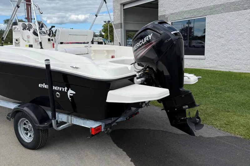 Slide: The Image of 2016 Bayliner Element F18 boat with Mercury outboard motor on trailer. - 6