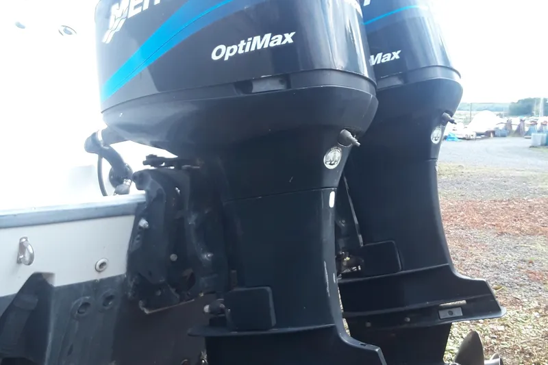 Slide: The Image of Twin Mercury OptiMax engines on a 2001 Boston Whaler 260 Outrage boat. - 11