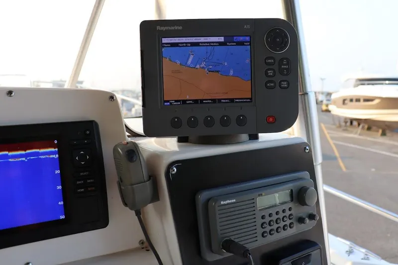 Slide: The Image of Control panel of a 2001 Boston Whaler 260 Outrage with navigation and communication equipment. - 12