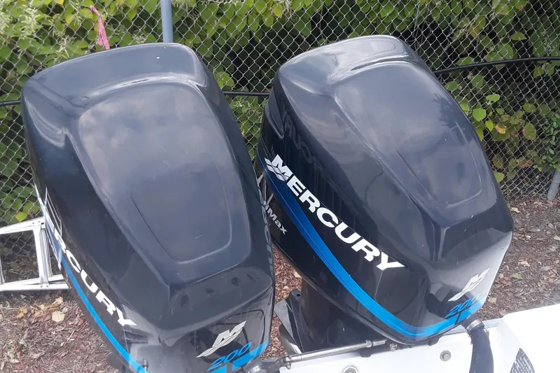 Slide: The Image of Twin Mercury outboard engines on a 2001 Boston Whaler 260 Outrage boat. - 14