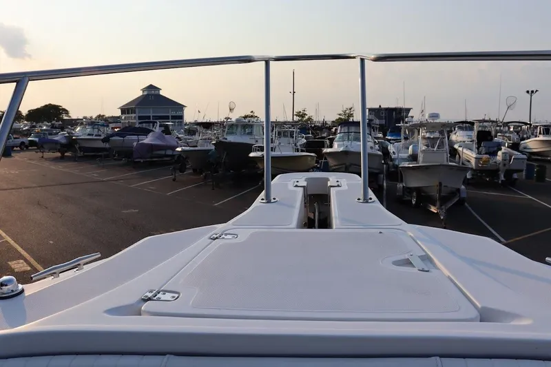 Slide: The Image of 2001 Boston Whaler 260 Outrage in marina, surrounded by various boats at sunset. - 15