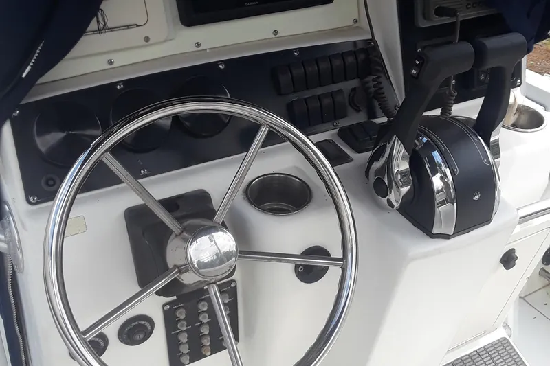 Slide: The Image of Steering console of a 2001 Boston Whaler 260 Outrage boat, featuring controls and gauges. - 18