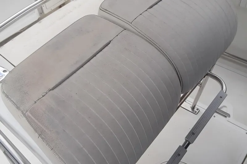 Slide: The Image of Worn seating on a 2001 Boston Whaler 260 Outrage boat, showing visible wear and tear. - 20