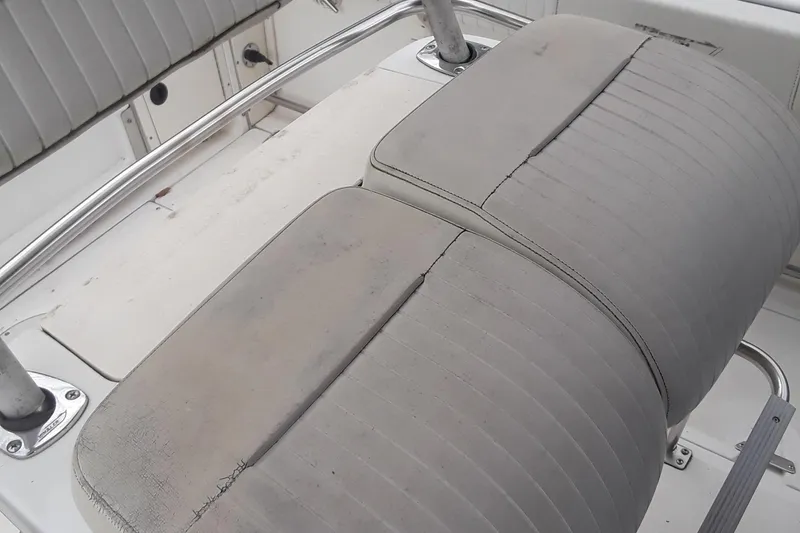 Slide: The Image of 2001 Boston Whaler 260 Outrage boat seat with visible wear and tear. - 21